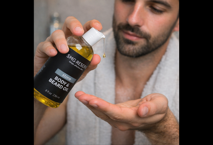Man applying Stone body and beard oil to skin during grooming routine
