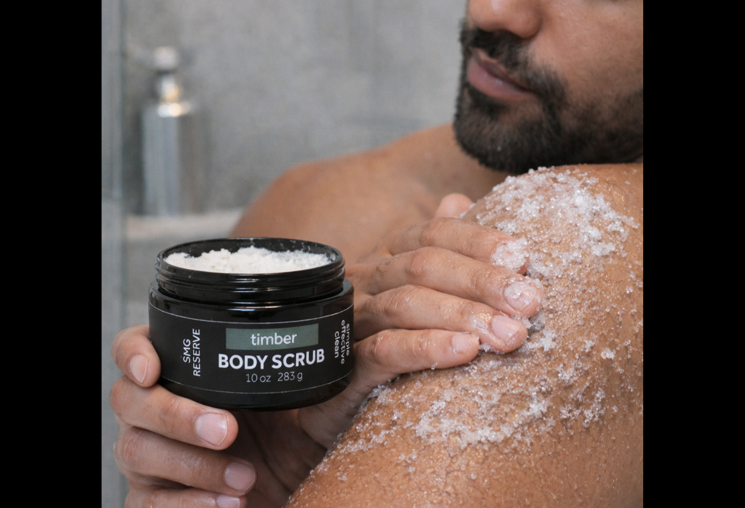 Man applying Timber exfoliating body scrub to skin during shower routine
