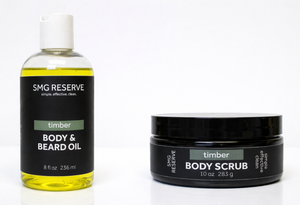 SMG Reserve Timber body scrub and body and beard oil shown side by side on a white background, featuring a men’s exfoliating scrub and lightweight grooming oil